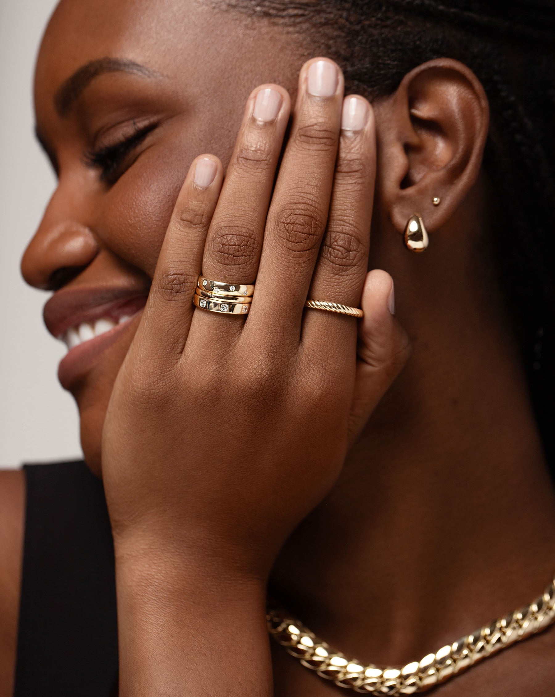 Twisted Cable Ring on pointer finger styled with weddings bands