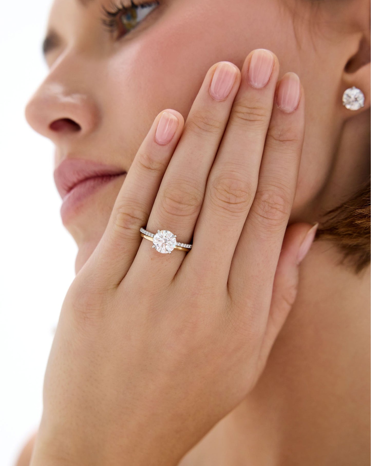 Model wearing Whisper Thin Band stacked with a Round Engagement Ring set in Whisper Thin Pave global