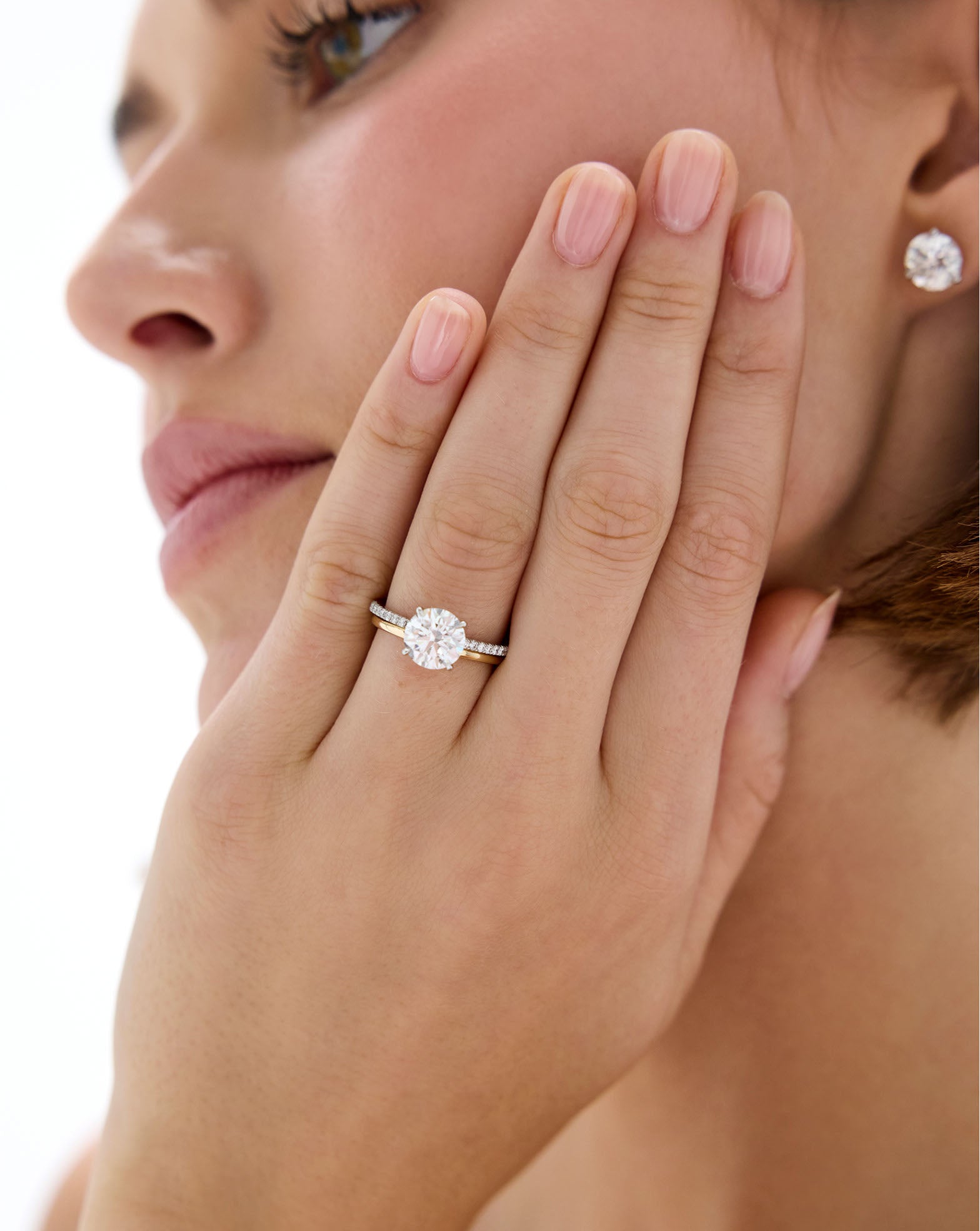 Model wearing Whisper Thin Band stacked with a Round Engagement Ring set in Whisper Thin Pave global
