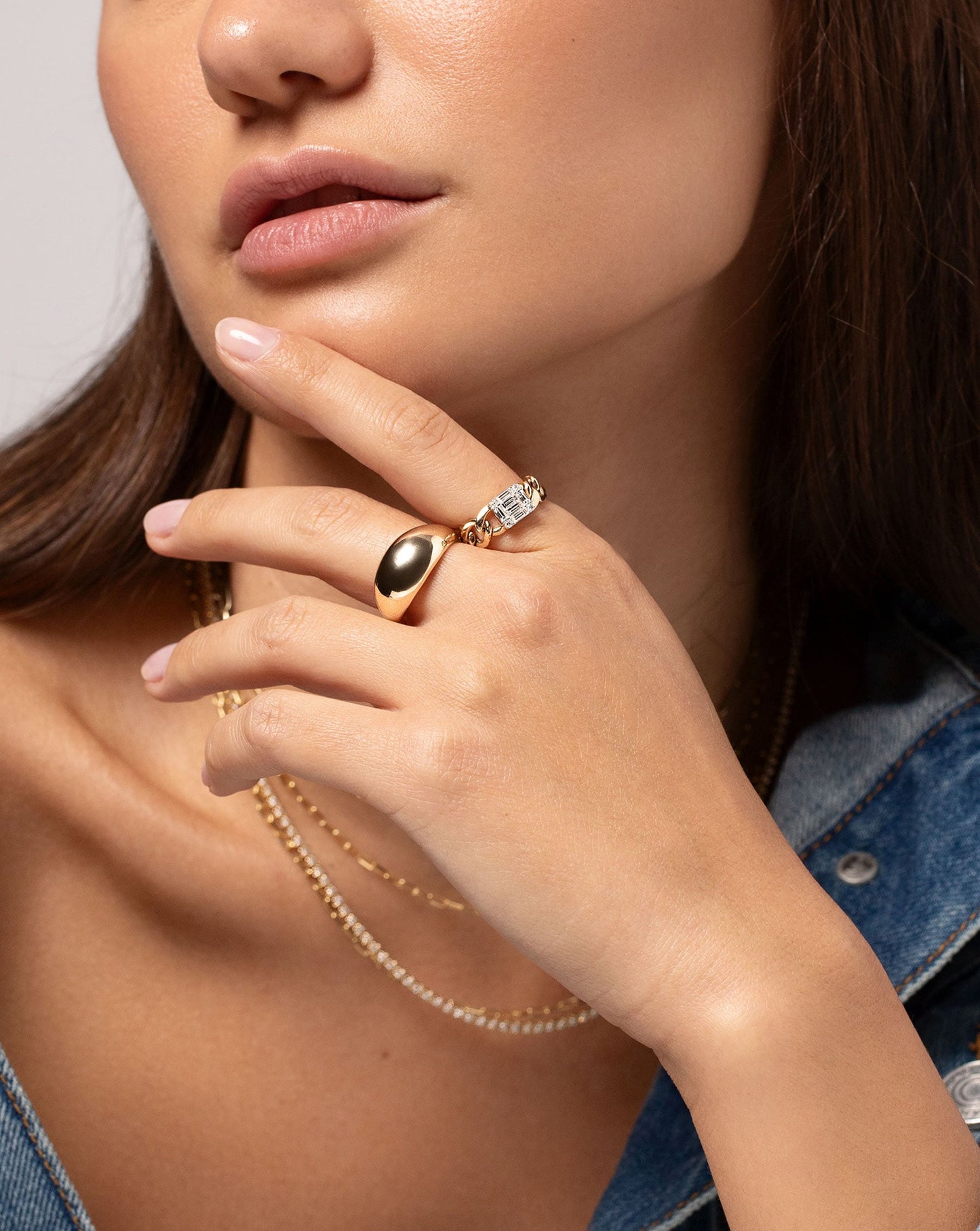 Emerald Illusion Curb Chain Ring show on hand of model along with the Jumbo Gold Cloud Ring