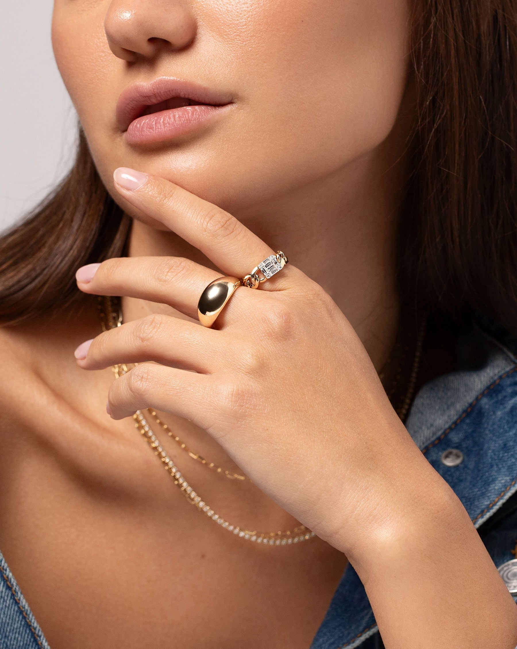 Emerald Illusion Curb Chain Ring show on hand of model along with the Jumbo Gold Cloud Ring