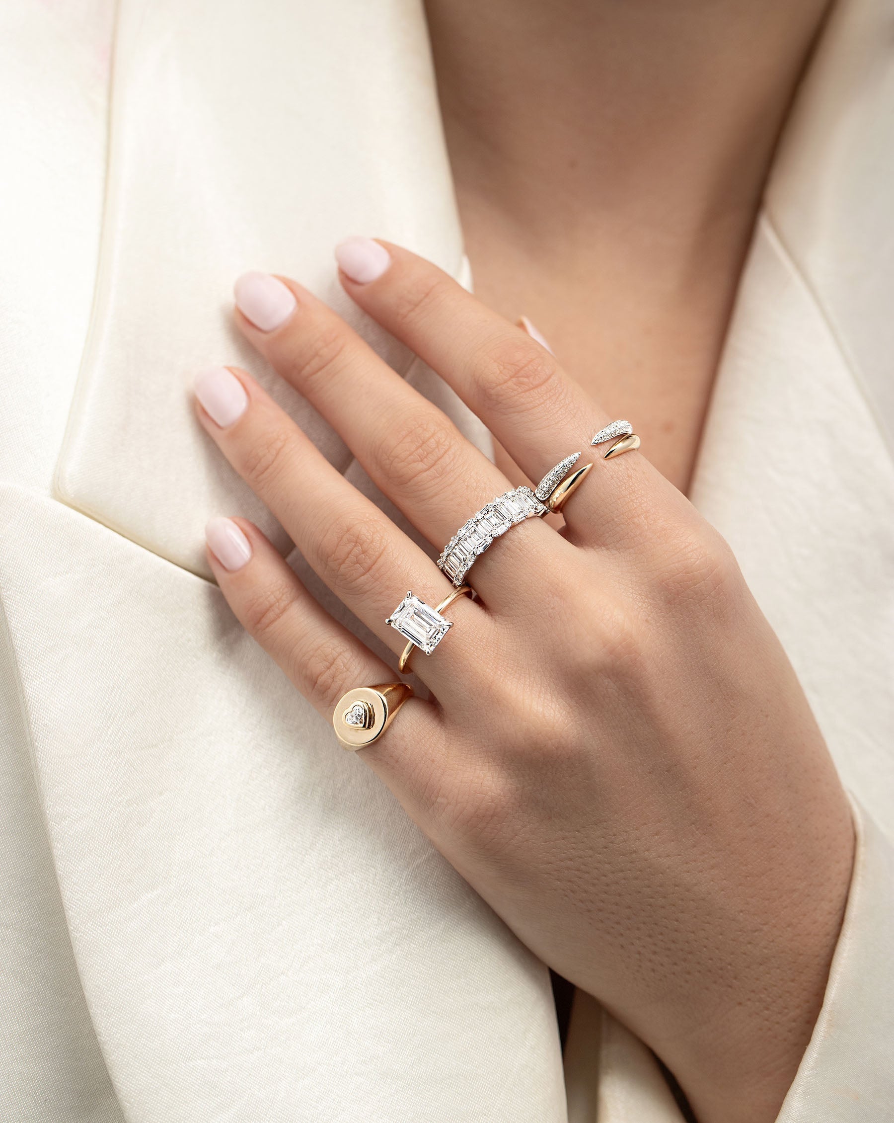 Diamond Signet Pinky Ring on pinky finger styled with other rings on model's hand