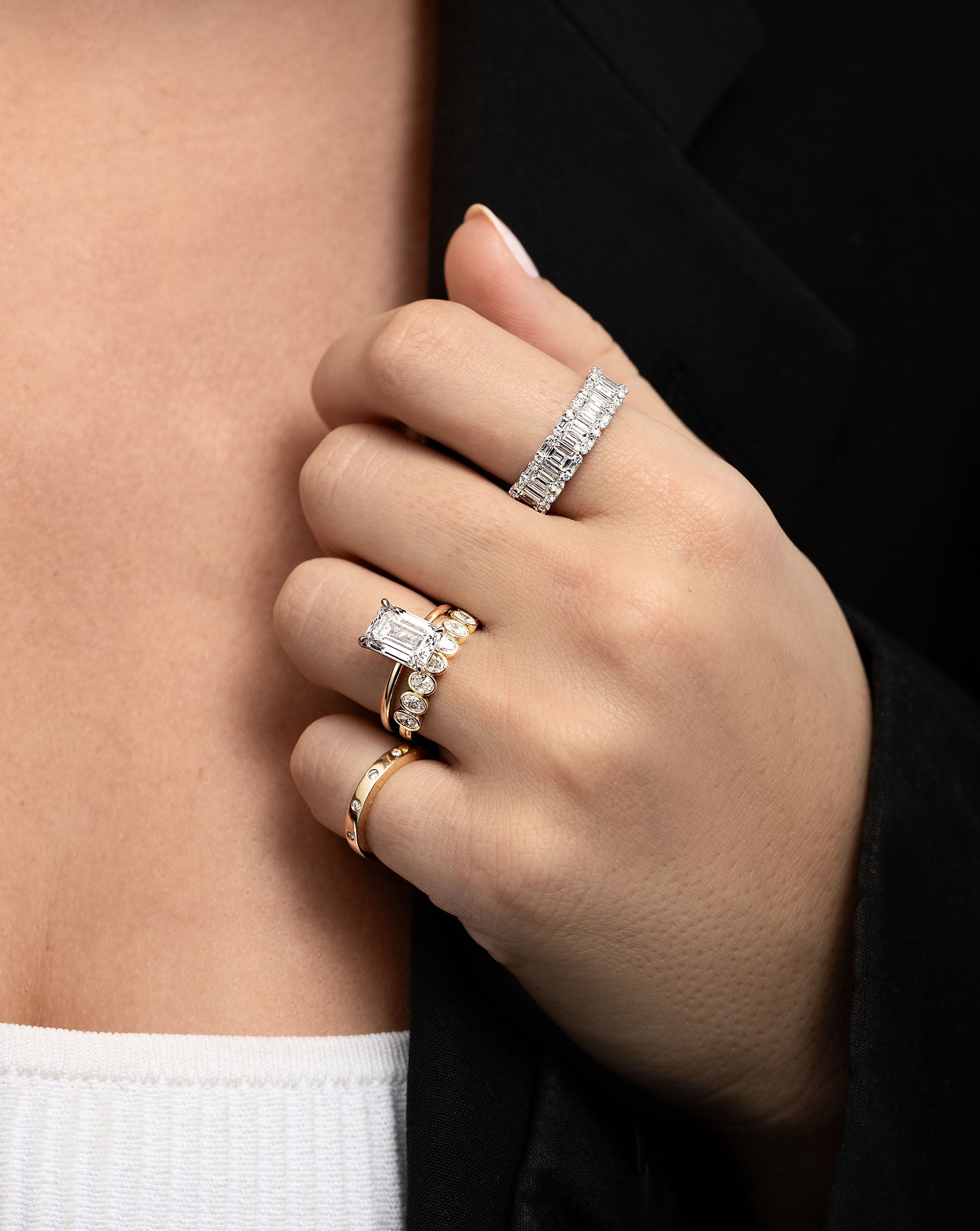 Emerald Illusion Ring on pointer finger styled with other rings on model