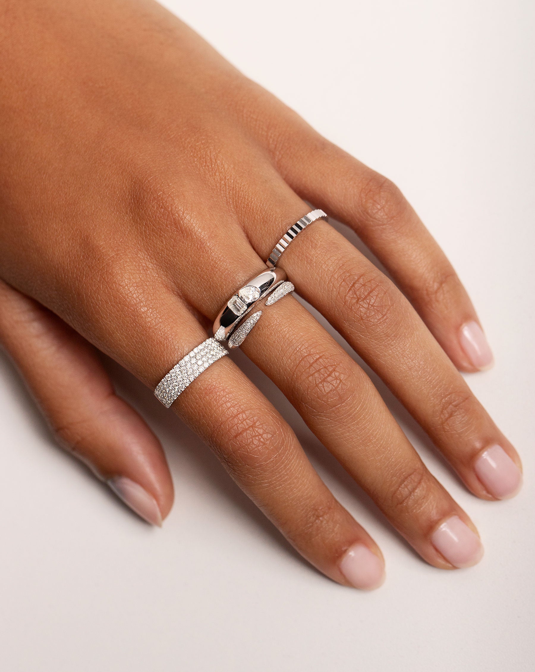 Model hand with 4 diamond and gold rings