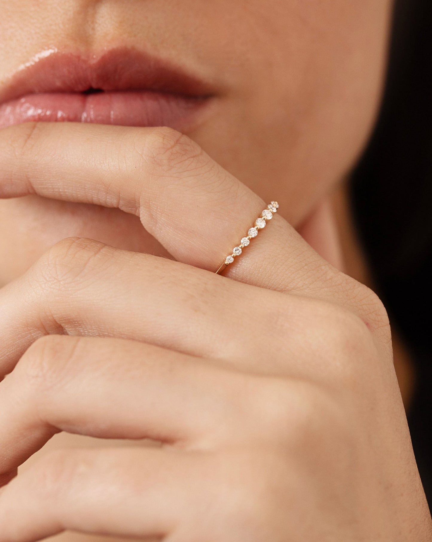 Graduated Single Prong Diamond Ring on model with hand on chin