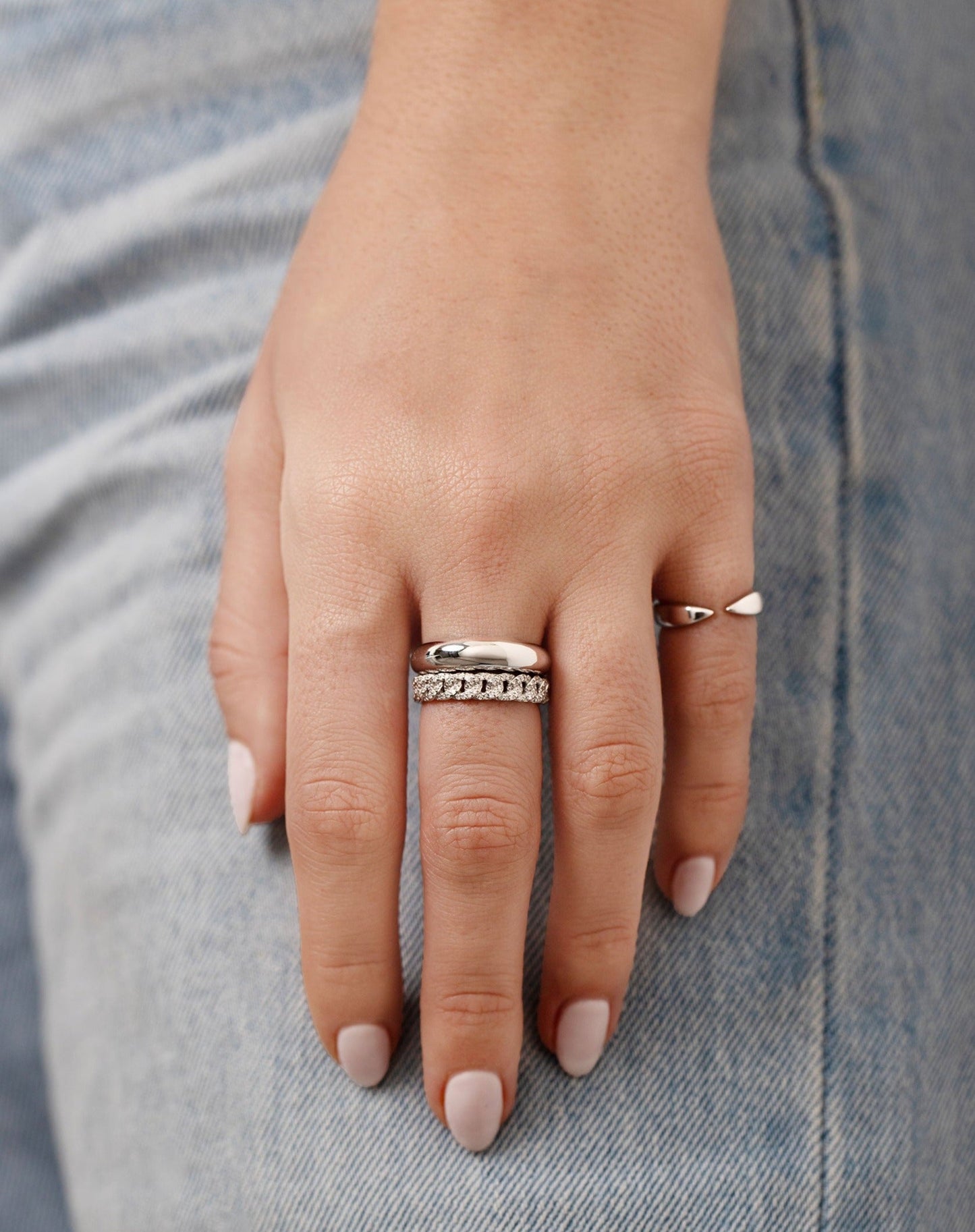 pave diamond chain ring in 14k white gold, white gold cloud ring, and white gold claw ring shown on model