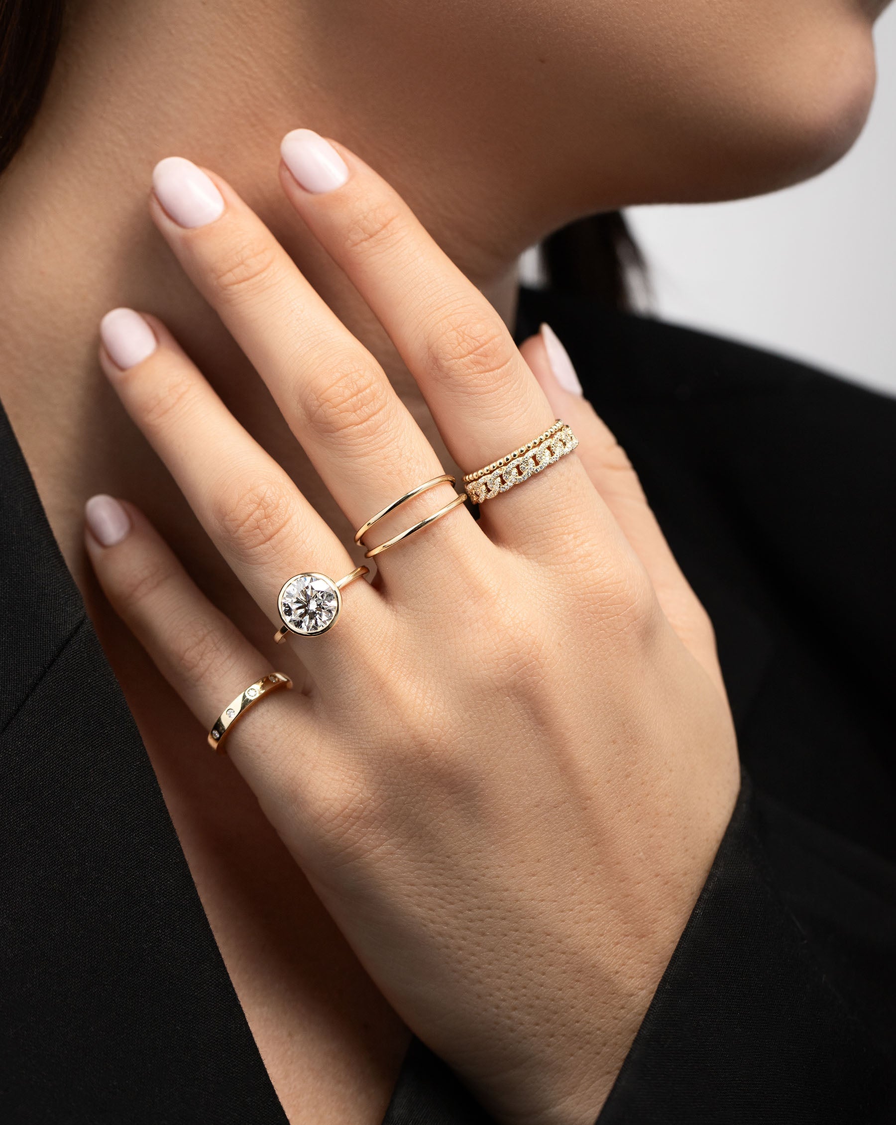 Pavé Diamond Chain Ring stacked with gold ring on pinter finger on model