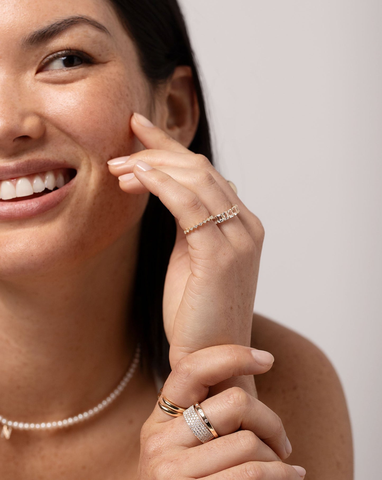 Petite Emerald Cut White Topaz Ring styled with other ring on model smiling
