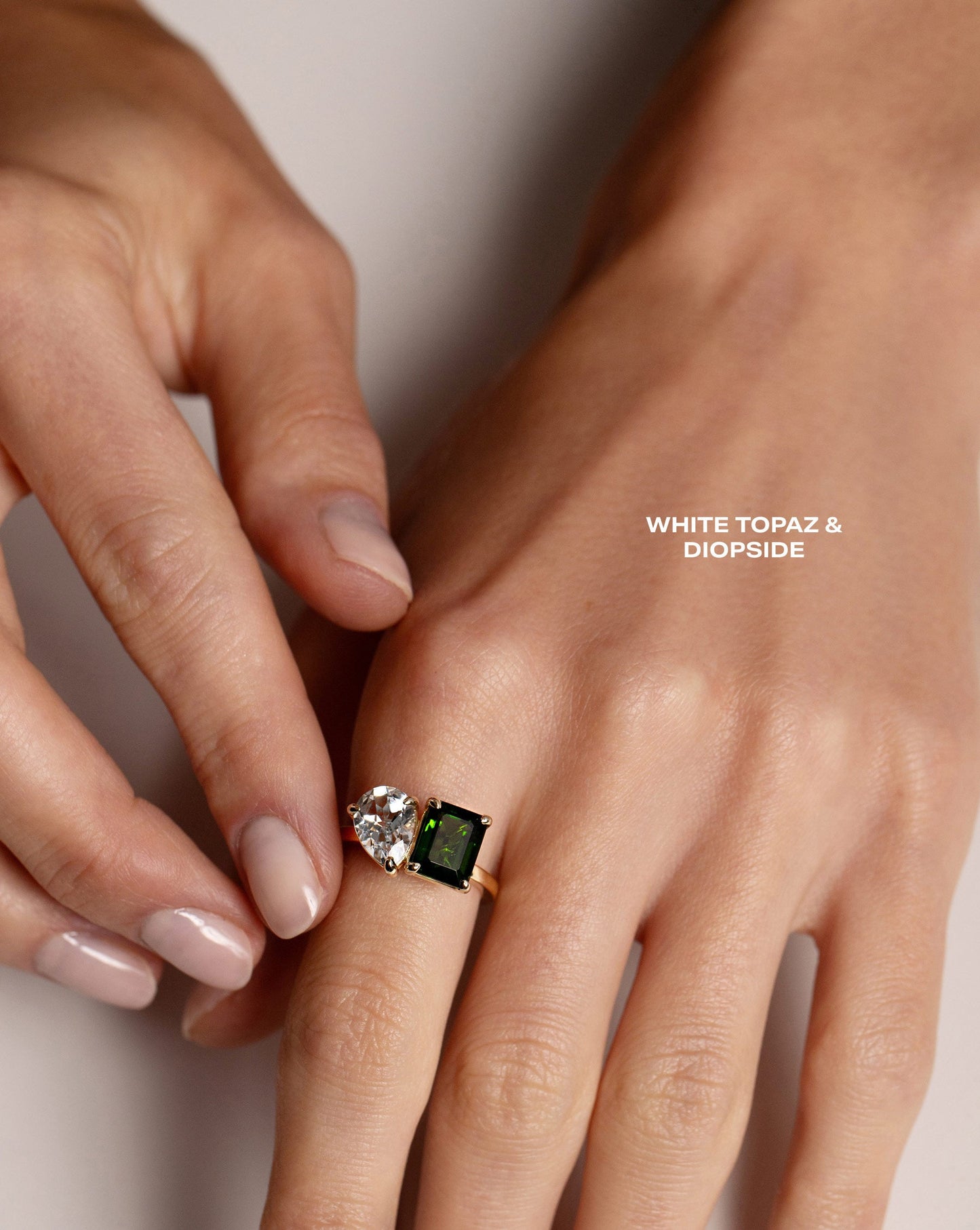 Toi et Moi Gemstone Ring with White Topaz and Diopside gemstones shown on hand of model