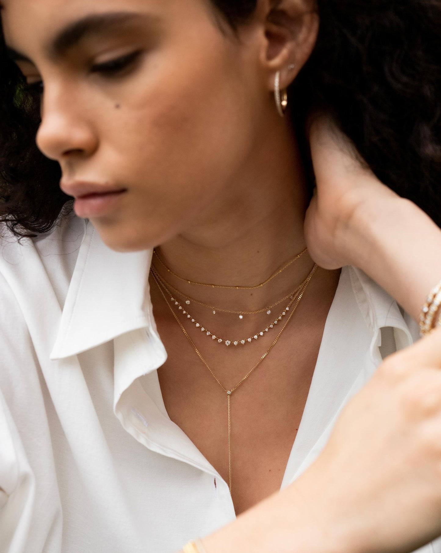 Ring Concierge Floating Diamond Necklace in 14K Yellow Gold styled with three additional layering necklaces.
