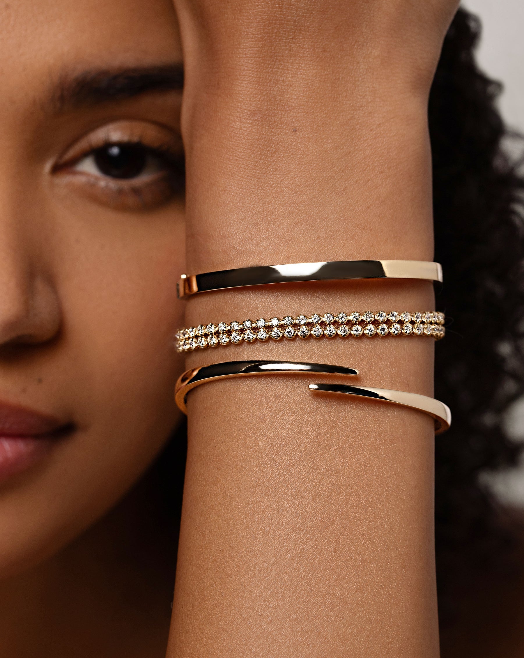 Stackable Gold Bangle styled with two other bracelets on wrist