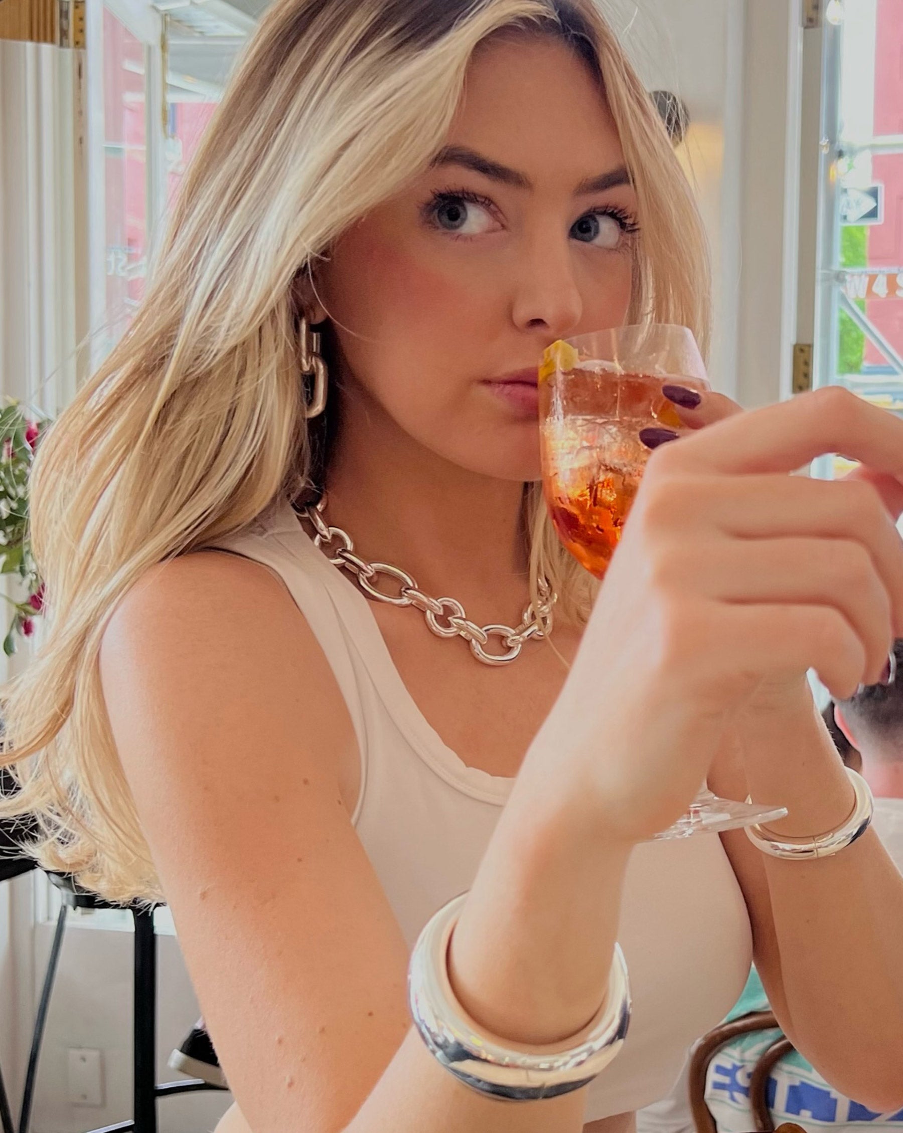 Ring Concierge Necklaces Statement Sterling - Oval Link Chain Necklace - on model wearing sterling silver collection and beige tank drinking an aperol spritz